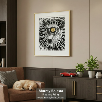 a close-up view of a chrome wheel with a prominent logo in the center. Jaguar Wire Wheel Art Print | Classic British Sports Car Decor by Murray Bolesta
