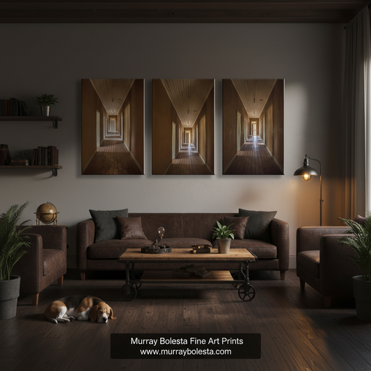 A three-panel canvas wall art set depicting a perspective hallway with warm brown and gold tones, displayed above a brown sofa in a modern, dimly lit living room. A watermark at the bottom reads 'Murray Bolesta Fine Art Prints'.