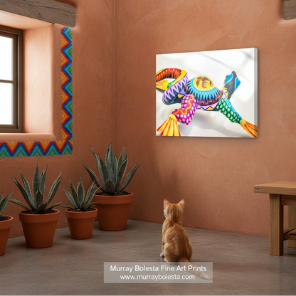 Oaxaca lizard by Murray Bolesta! A colorful wall art print depicting a stylized, vibrant bird with rainbow feathers, shown hanging on a terracotta-colored wall in a room with a cat sitting below it and potted plants.