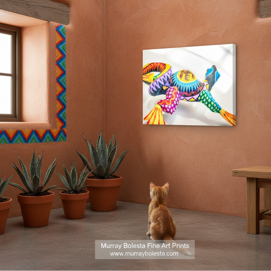 Oaxaca lizard by Murray Bolesta! A colorful wall art print depicting a stylized, vibrant bird with rainbow feathers, shown hanging on a terracotta-colored wall in a room with a cat sitting below it and potted plants.