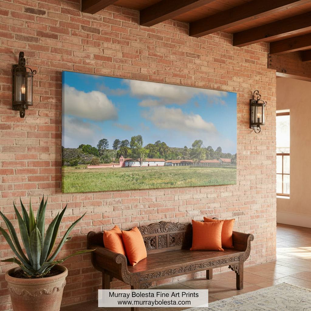 a serene rural landscape with a large grassy field, a few buildings, and a line of trees in the background. La Purisima Mission Panoramic Art - Lompoc California Wall Print by Murray Bolesta