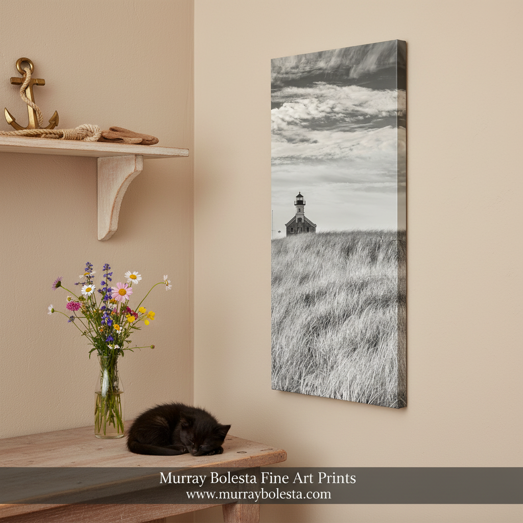 A sepia photograph of a lighthouse standing in a grassy field with a cloudy sky in the background. Block Island Beach Grass Lighthouse | Vertical Rhode Island Art by Murray Bolesta