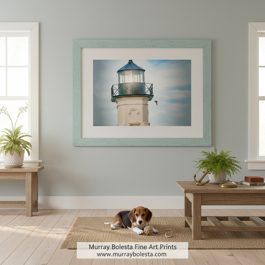 A lighthouse with a bird flying in the background, set against a cloudy sky. Block Island North Lighthouse Art Print | Seabirds Coastal Decor by Murray Bolesta!