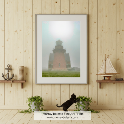 A tall brick lighthouse with a round top stands in a foggy landscape, surrounded by a grassy field. Block Island South East Lighthouse Art | Rhode Island Ocean Fog by Murray Bolesta