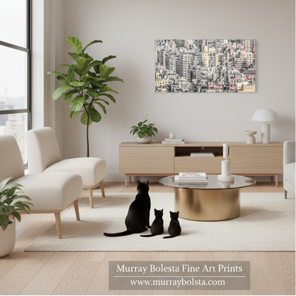 Upper East Side Manhattan by Murray Bolesta! A framed cityscape art print hangs on a light beige wall in a modern living room. The room features a light wood console, a round gold coffee table, white armchairs, and several potted plants.