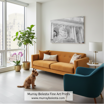 New York Public Library lions! A black and white architectural art print by Murray Bolesta is displayed on a white wall in a modern living room setting with an orange sofa, a teal armchair, and a small dog.
