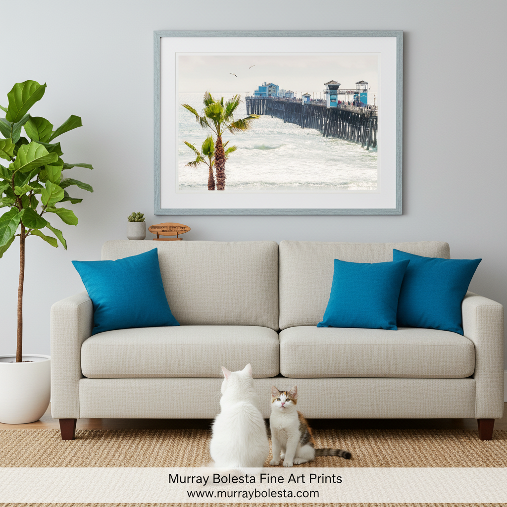 A wooden pier extends into the ocean, with a few people visible on the pier. Palm trees are present on the left side of the image, and the sky is overcast. Oceanside Pier Print – San Diego Southern California Art by Murray Bolesta