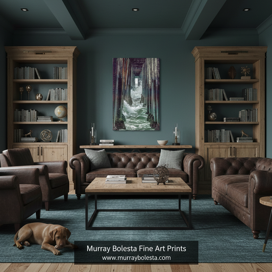 A living room with dark teal walls, wooden built-in bookshelves, a brown tufted sofa, matching armchairs, a coffee table, and a blue rug. A framed vertical art print hangs above the sofa, showing a moody forest path with purple, green, and white tones.