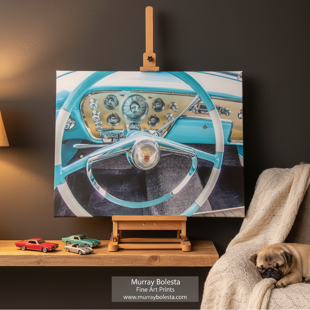Packard car art by Murray Bolesta! A canvas art print depicting a vintage car dashboard and steering wheel in turquoise, cream, and chrome, displayed on a wooden easel in a styled room setting with a pug dog on a couch in the background.