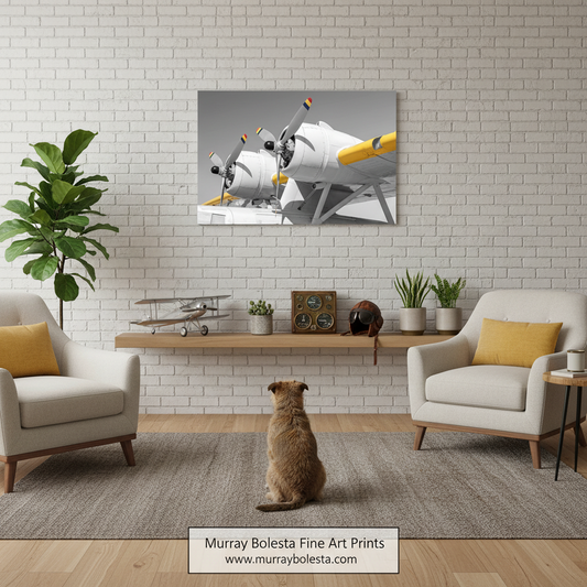 PBY float plane by Murray Bolesta! A framed wall art print showing two vintage airplanes in grayscale with yellow accents, displayed above a shelf in a styled living room with two armchairs, plants, and a dog sitting on the floor. 