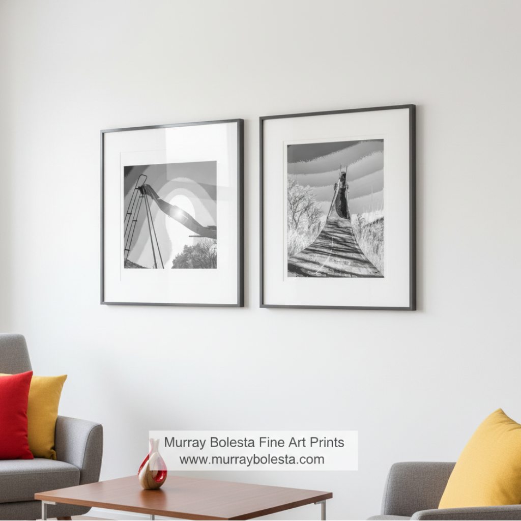 Two black and white artworks of a bridge over water with trees in the background. Surreal Black and White Playground Ruins Art in Set of 2 Prints by Murray Bolesta