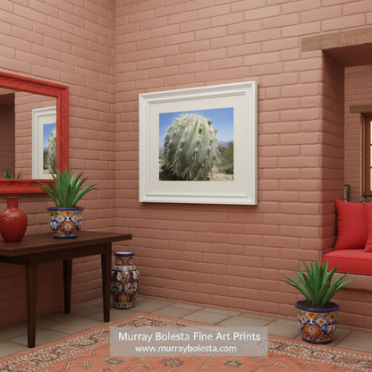 A close-up view of a cactus plant with numerous spines and small green flowers on its surface, set against a clear blue sky. Cactus Decor from Arizona Desert | Unique Southwest Art Print by Murray Bolesta