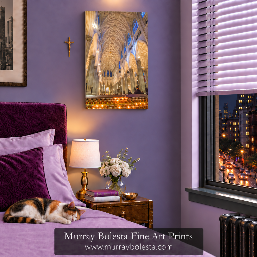 A bedroom scene with a purple wall, a bed in lavender bedding, a cat resting on the bed, a bedside lamp and flowers, and a window showing a city night scene. A vertical art print of a cathedral interior hangs on the wall. St patrick's cathedral art by Murray Bolesta