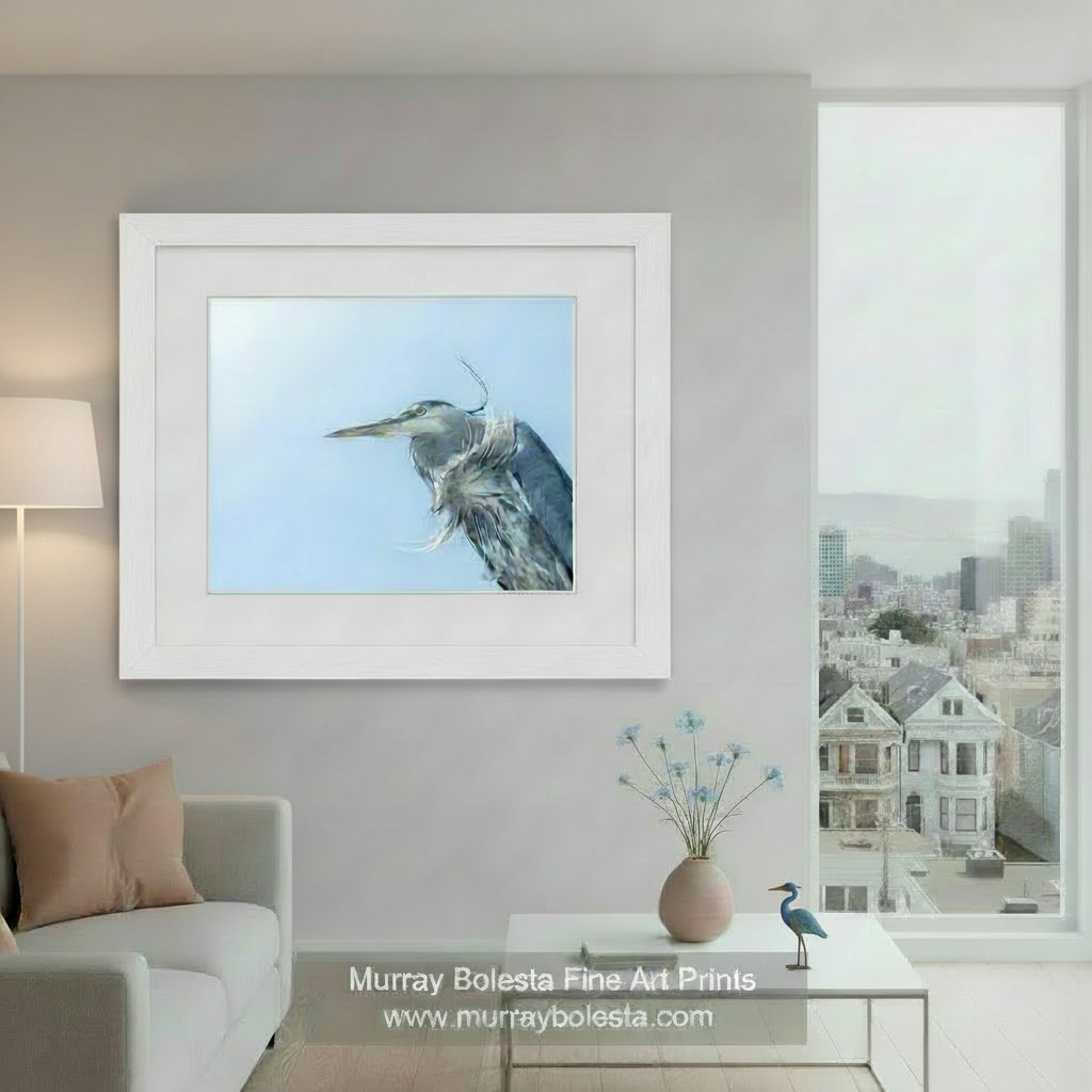 A close-up photograph of a bird with a long beak and gray and white feathers against a clear blue skyBlue Heron Bird Photography - San Francisco Bay Avian Artwork by Murray Bolesta