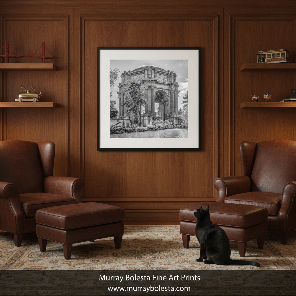 Palace of Fine Arts San Francisco! A framed black and white architectural art  hangs on a wood-paneled wall in a styled living room with two brown leather armchairs, ottomans, a rug, and a black cat sitting on the floor. A watermark at the bottom reads 'Murray Bolesta Fine Art Prints www.