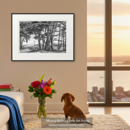 A black and white photograph depicting a park with a bridge in the background, surrounded by trees. Presidio San Francisco Bay Art | Golden Gate Bridge in B&W by Murray Bolesta