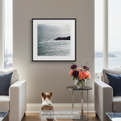 a serene coastal scene with a rocky shoreline, calm waters, and a small lighthouse perched atop the cliff. Marin Headlands Point Bonita Lighthouse Art in Black & White, San Francisco art by Murray Bolesta