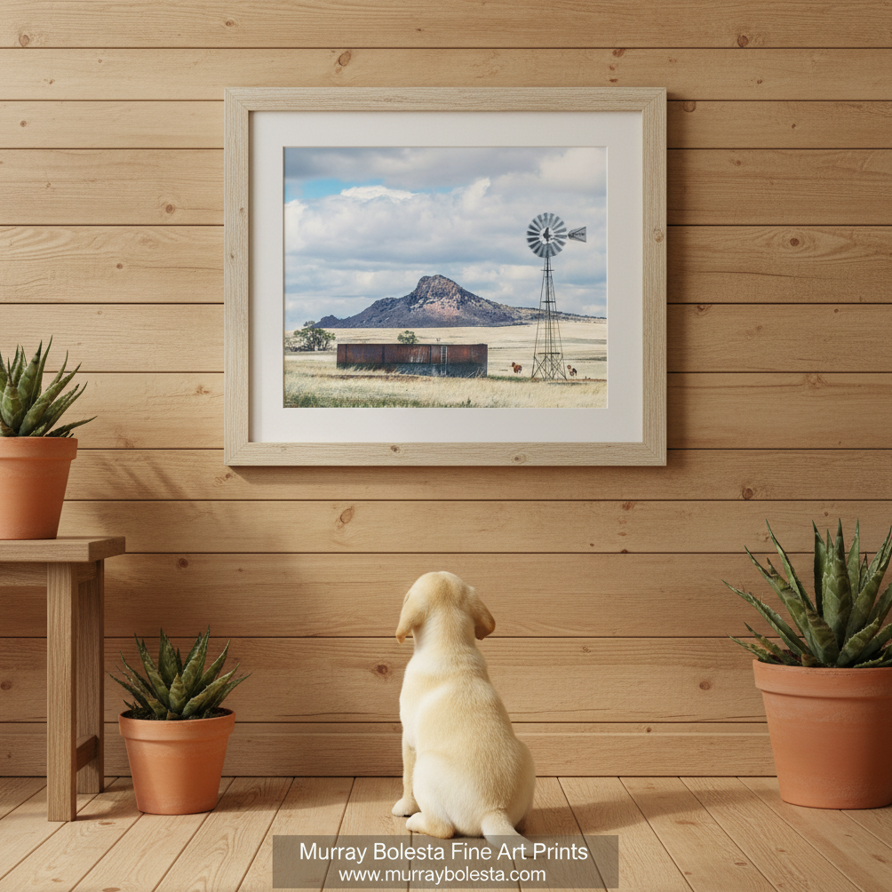 A windmill stands in a field with a large mountain in the background, and a few horses are visible in the distance. Western Horse Ranch Windmill | San Rafael Valley Equestrian Art by Murray Bolesta