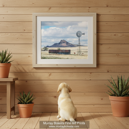 A windmill stands in a field with a large mountain in the background, and a few horses are visible in the distance. Western Horse Ranch Windmill | San Rafael Valley Equestrian Art by Murray Bolesta