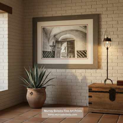 A black and white image of an interior space with a large wooden door, a cross, and a tiled wall. San Xavier Mission Black & White Art - Tucson Arizona Church Print by Murray Bolesta