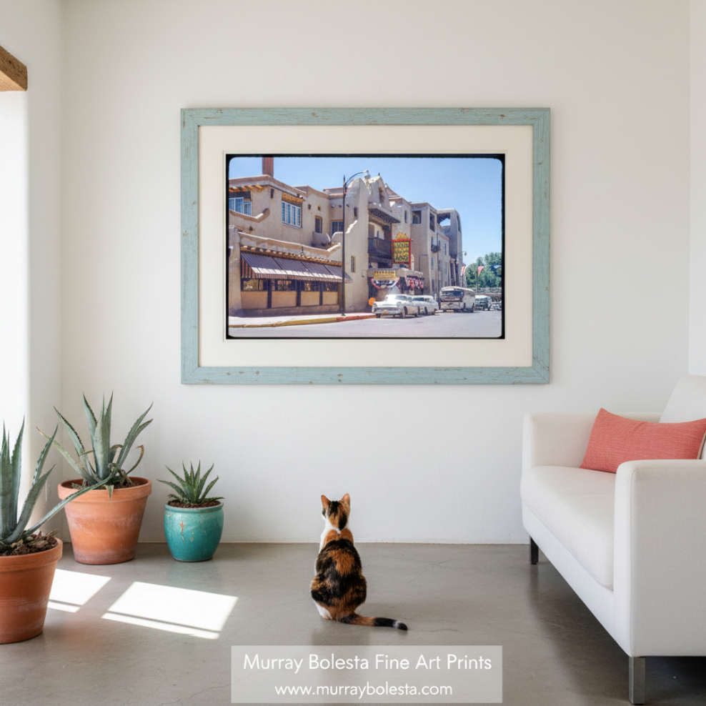 A vintage photograph of the La Fonda Hotel in Santa Fe, New Mexico, capturing the historic building with a black border around the image. Presented by Murray Bolesta!