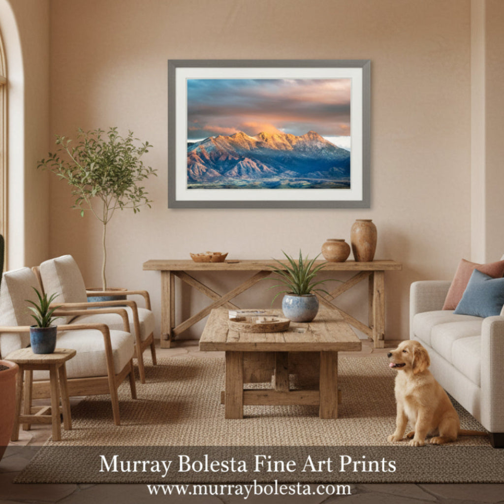 Santa Rita Mountains AZ. a breathtaking mountain range with snow-capped peaks bathed in warm, golden light, set against a dramatic sky with vibrant orange and pink clouds. Tucson Santa Rita Mountains Wall Art – Madera Canyon Print