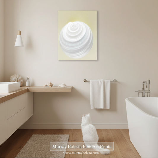 By Murray BolestaA white spiral shell art print on a pale yellow background, displayed on a beige wall in a modern bathroom with a white cat sitting below it. 