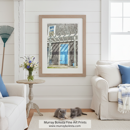 a blue wooden door with a white frame, set in a shingled building with a white trellis over the door. Block Island Shingle Home Art | New England Blue Door Cottage Print by Murray Bolesta