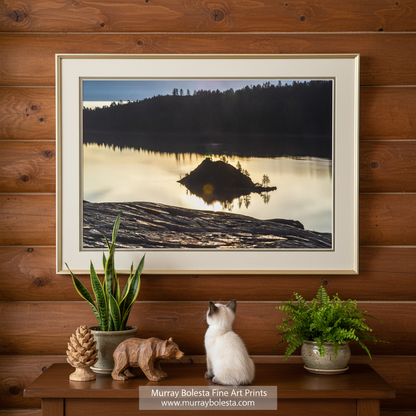 A serene lake surrounded by a forest, with a small island in the center reflecting the warm glow of the setting sun. Lake Tahoe Emerald Bay Wall Art | Peaceful Sierra Sunrise Landscape by Murray Bolesta!