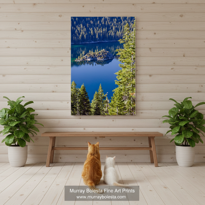 a serene lake surrounded by a dense forest, with the calm water reflecting the lush greenery and the clear blue sky above. Lake Tahoe Art Print | Emerald Bay & Fannette Island Sierra Nevada art by Murray Bolesta!