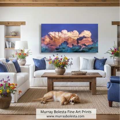 a stunning cloud formation against a vibrant blue sky, with the clouds displaying a mix of pink, orange, and white hues. Storm Clouds and Sky Panoramic Art Print - Desert Monsoon Photography by Murray Bolesta
