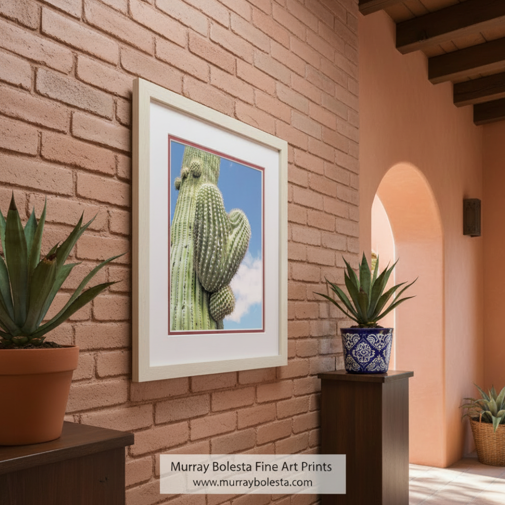 A tall cactus with numerous spines and a heart-shaped growth on its side, set against a clear blue sky. Cactus Heart Wall Art | Southwestern Nature Print for Home Decor by Murray Bolesta