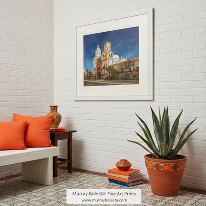 A large, ornate building with two towers and a dome, surrounded by a well-maintained garden and a paved walkway. San Xavier Mission Moonlight Art - Arizona Desert Night Photography by Murray Bolesta