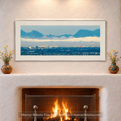 City of Tucson Arizona panoramic art with Tucson Mountains in background with winter clouds. Art by Murray Bolesta