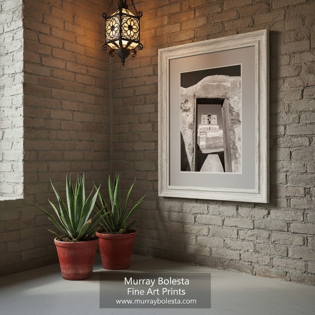 A black and white photograph of a dilapidated building with a large archway, revealing a smaller structure inside. Arizona Desert Mission Black & White Art - Adobe Church Print by Murray Bolesta