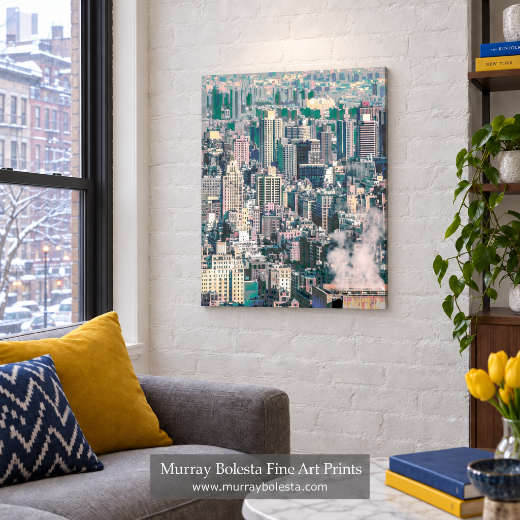 A vertical canvas art print of a dense city skyline with green trees and white steam, displayed on a white brick wall in a modern living room setting next to a gray sofa and yellow pillows. NYC winter art by Murray Bolesta
