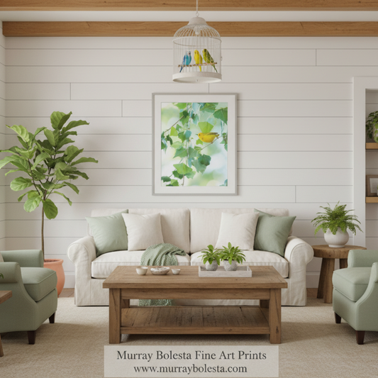 Spring Warbler birds! A framed art print featuring a watercolor green leafy design with a small yellow bird, displayed on a white shiplap wall above a beige sofa in a styled living room. The text 'Murray Bolesta Fine Art Prints' is visible at the bottom.