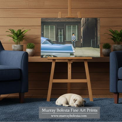 Charles Zeller Morgantown West Virginia. A framed or canvas-style art print showing a street scene with a blue car and a person standing outside a building, displayed on a wooden easel in a living-room setting. A sleeping dog lies on a blue rug below, with two blue armchairs and potted plants around the easel.